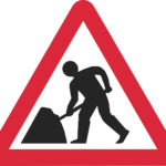 Triangular warning road sign with red edge showing man digging