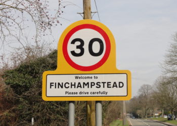 Yellow welcome to Finchampstead gateway sign with 30 mph roundel