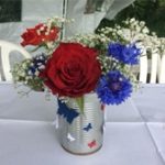 Silver can with red rose and blue cornflowers